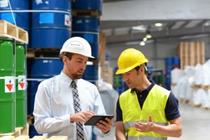 Men in chemical plant holding tablet