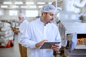 Supervisor Inspecting Food Quality with Tablet