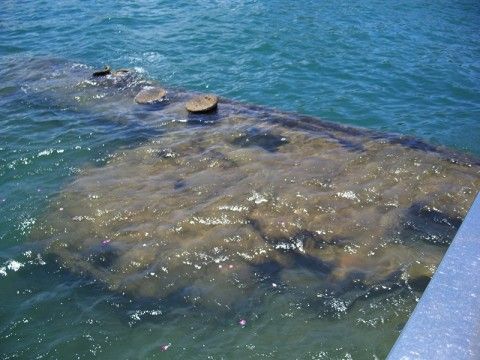 Another view of part of the sunken USS Arizona from the memorial structure at Pearl Harbor