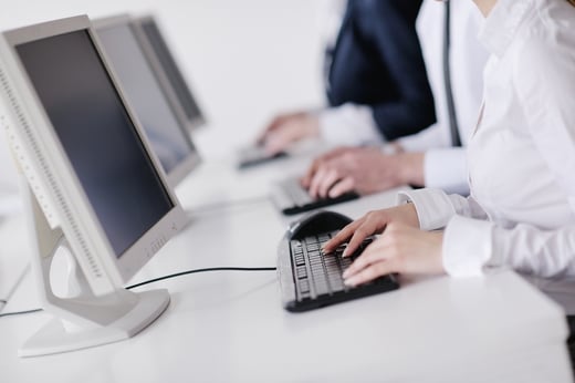 Person typing on desktop computer