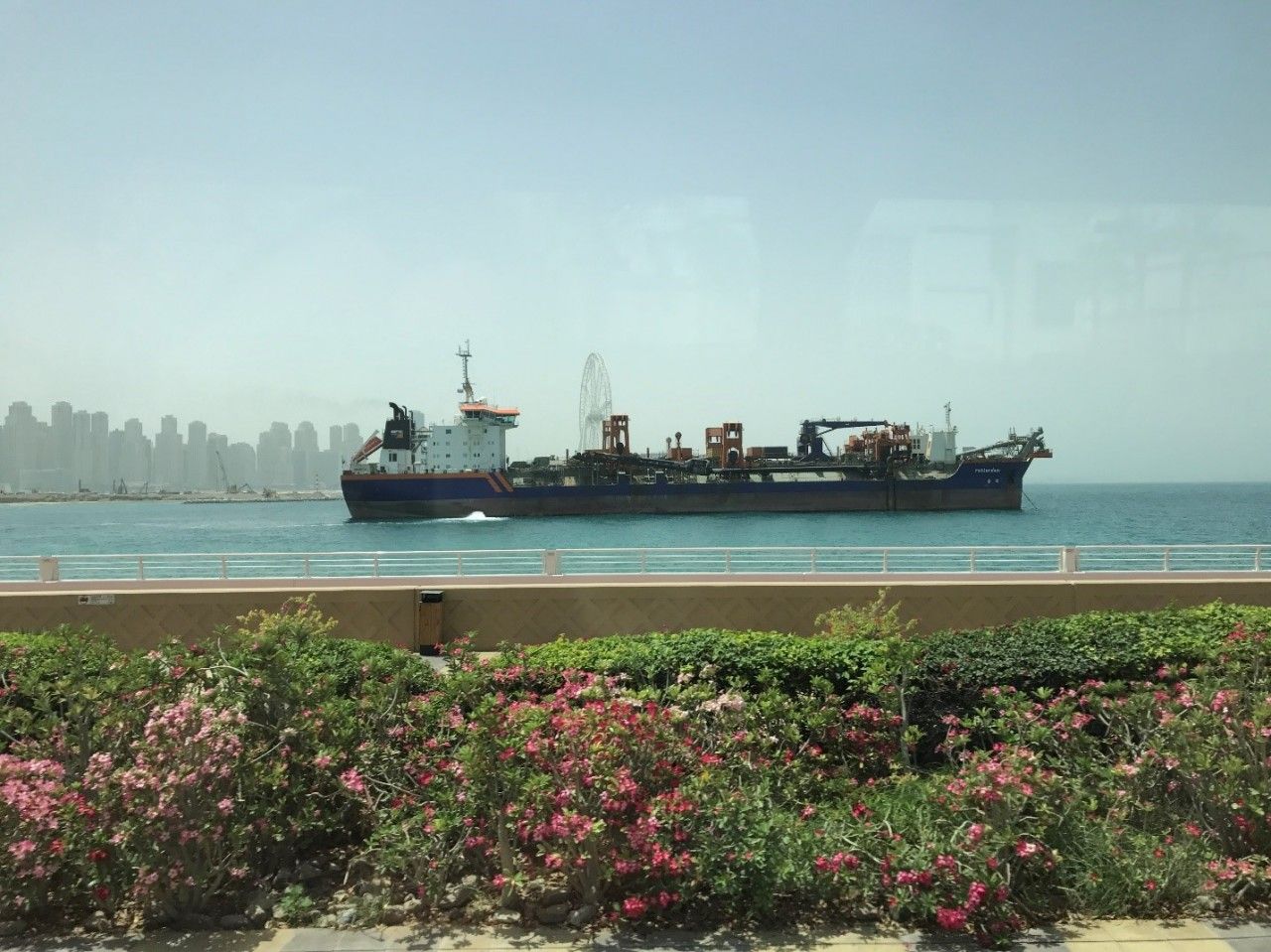 Dredging ship with the “Dubai Eye” Ferris wheel (still under construction) in the background